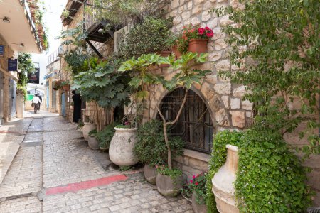 Photo for Safed, Israel, July 01, 2023 : Quiet Alkabets street with a stone pavement and stone walls of houses in the old part of Safed city in northern Israel - Royalty Free Image