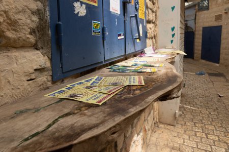 Photo for Safed, Israel, July 01, 2023 : Wooden counter with brochures with religious content in Hebrew scattered on it in the old part of Safed city in northern Israel - Royalty Free Image