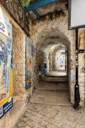 Photo for Safed, Israel, July 01, 2023 : The tunnel passes under residential buildings on a quiet street in the old part of Safed city in northern Israel - Royalty Free Image