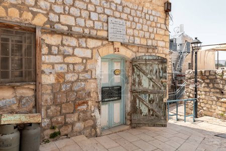 Photo for Safed, Israel, July 01, 2023 : Vintage wooden entrance doors in an old stone house on a quiet street in the old part of Safed city in northern Israel - Royalty Free Image