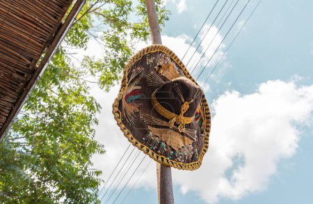 Photo for Safed, Israel, July 01, 2023 : An old Mexican sombrero hat hangs on a pole as a decoration in the Safed city old part of in northern Israel - Royalty Free Image