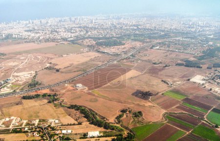 View from window of an airplane taking off from Ben Gurion Airport and flying over Tel Aviv city in Israel towards the Mediterranean Sea and Europe