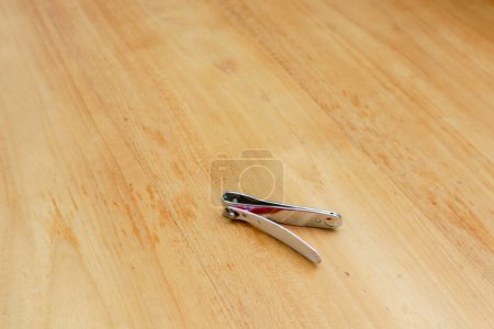Photo for A nail clipper on a wooden table - Royalty Free Image