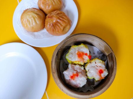 Chicken dimsum served in bamboo plate. Dimsum is a large range of small dishes that Cantonese people traditionally enjoy in restaurants for breakfast and lunch.