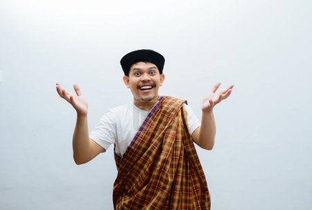 Moslem Asian man smiling happy to greeting during Ramadan celebration with both arms open