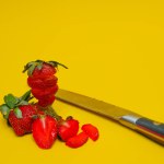 photo of strawberries isolated on yellow background