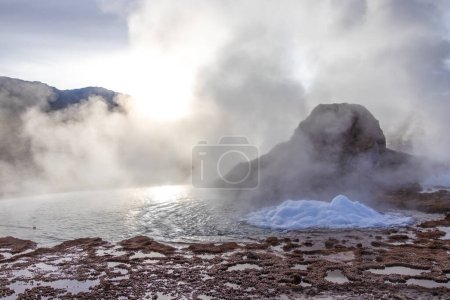 Photo for Boling water and smoke at El Tatio Geysers in the volcanic area of Atacama desert on the border of Chile with Bolivia - Royalty Free Image
