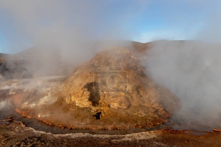 Photo for Boling water and smoke at El Tatio Geysers in the volcanic area of Atacama desert on the border of Chile with Bolivia - Royalty Free Image