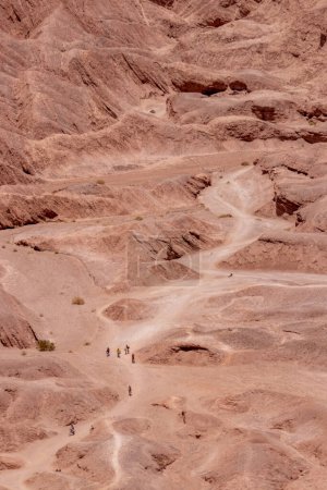 Photo for People crossing paved paths in the Death Valley of Atacama, the most arid desert of the world in Chile - Royalty Free Image