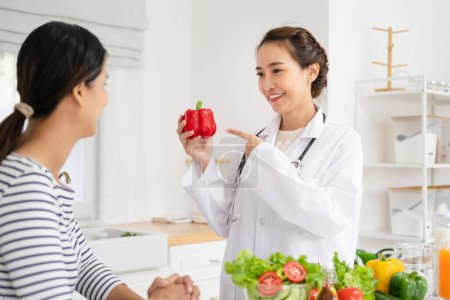 Photo for Young nutritionist consulting patient at table in clinic - Royalty Free Image