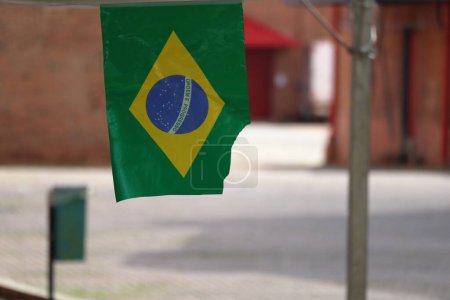 Photo for Brazilian flag, waving. High quality photo. Brazilian paper flag hanging on a wire as a decoration element in a touristic place - Royalty Free Image