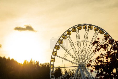 Illuminated Ferris wheel in the evening.
