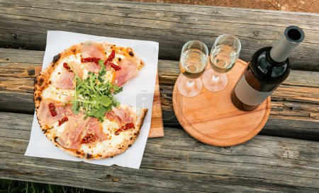 Pizza and wine in nature in a beautiful place.