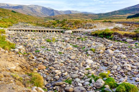 Panoramic of the Barbellido river with its round stones from the El Mellizo refuge area in the Sierra de Gredos