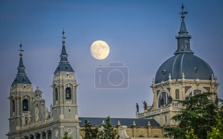 Sunset image of the Almudena Cathedral in Madrid with the full moon in the background