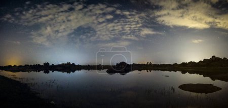 panoramic against the light of dawn in the lagoons of Los Barruecos with large granite masses