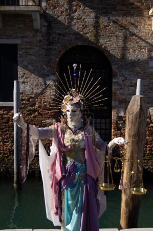 Photo for Woman on carnival in Venice, Italy. Vancian masks. Festival in Italy. Colorful outfit, scales, and dagger. Before Covid-19 - Royalty Free Image