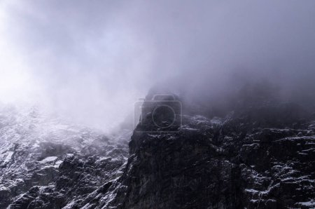 Photo for Whispers of Winter: Tatra Mountains in Poland, Enveloped by Mist, Displaying the Rugged Beauty of Snow-Dusted Rock Formations Against a Moody Sky. A Testament to Nature's Unyielding Grandeur. - Royalty Free Image