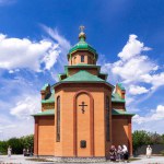 Consecration of Holy Resurrection Church by Metropolitan Epiphanius on June 2, 2023, in Brusilov. Devotees attend the inaugural liturgy under the expansive blue sky, marking a day of spiritual significance and architectural beauty.