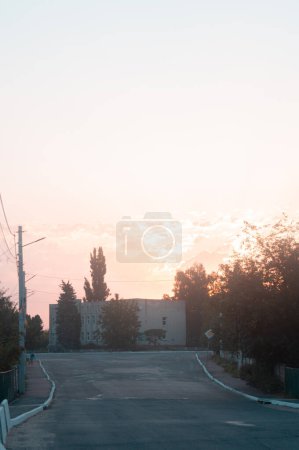 Photo for Early morning in Brusyliv as dawn breaks, casting a warm glow over the tranquil streets and pastel skies, heralding a serene start to the day. - Royalty Free Image