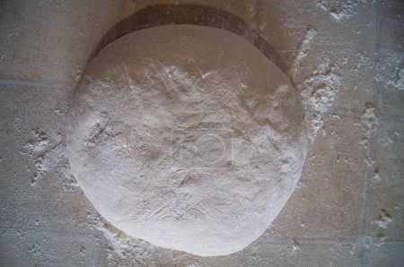 Photo for Pristine dough lies ready, a canvas for the baker's art. Poised for transformation into crusty breads or delicate pastries. A celebration of culinary craft. Raw dough, dusted with flour, awaits the artist's touch for the ultimate baked masterpiece. - Royalty Free Image