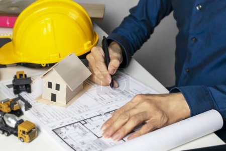 Foto de Engineers sit and work on building design and system work.,construction work safety,construction business and real estate - Imagen libre de derechos
