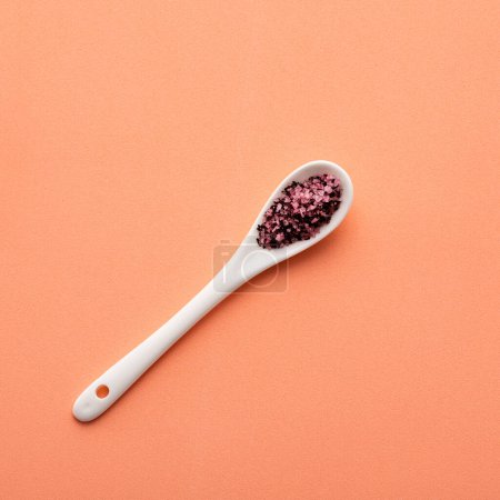 Photo for Natural hibiscus salt in wooden spoon - fine crystals for seasoning - Royalty Free Image