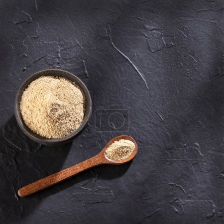 Photo for Organic Lepidium meyenii powder in the spoon - Peruvian Maca - Royalty Free Image