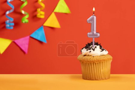 Téléchargez les photos : Bougie numéro 1 gâteau d'anniversaire sur fond orange avec bunting - en image libre de droit