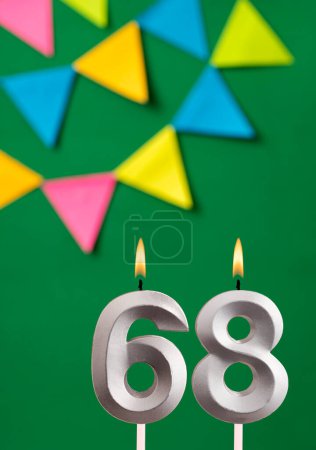 Foto de Tarjeta de cumpleaños vertical con número 68 vela Fondo verde con banderines - Imagen libre de derechos