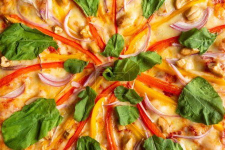 Photo for Vegetable pizza al forno - Red and yellow paprika, red onion, garlic, arugula, cashew with sesame oil - Royalty Free Image