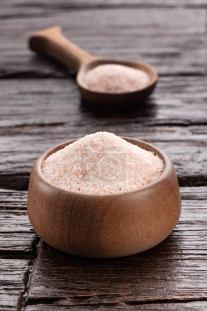 Photo for Himalayan pink salt in bowl and spoon - Rustic wooden background - Royalty Free Image