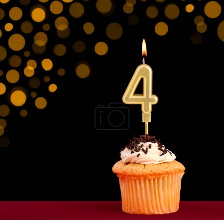 Photo for Birthday candle with cupcake - Number 4 on black background with out of focus lights - Royalty Free Image