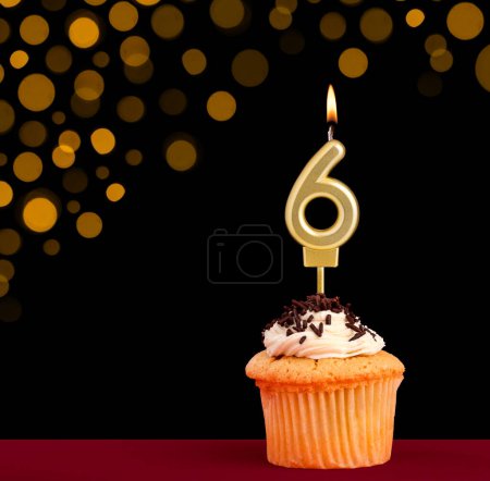 Photo for Birthday candle with cupcake - Number 6 on black background with out of focus lights - Royalty Free Image