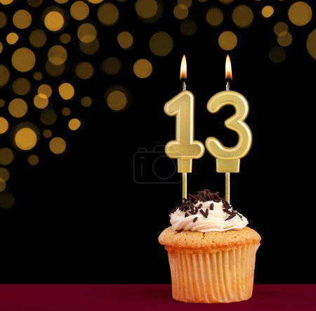Photo for Number 13 birthday candle - Cupcake on black background with out of focus lights - Royalty Free Image