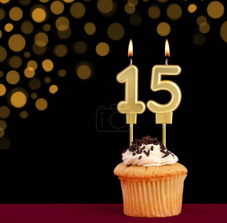 Photo for Number 15 birthday candle - Cupcake on black background with out of focus lights - Royalty Free Image