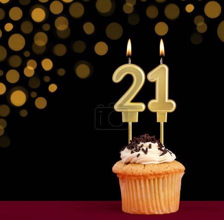 Photo for Number 21 birthday candle - Cupcake on black background with out of focus lights - Royalty Free Image