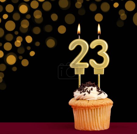 Photo for Number 23 birthday candle - Cupcake on black background with out of focus lights - Royalty Free Image