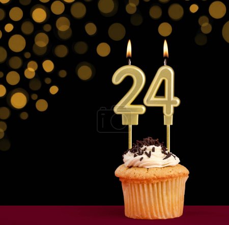 Photo for Birthday candle with cupcake - Number 24 on black background with out of focus lights - Royalty Free Image