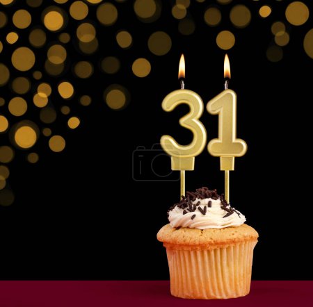 Photo for Number 31 birthday candle - Cupcake on black background with out of focus lights - Royalty Free Image