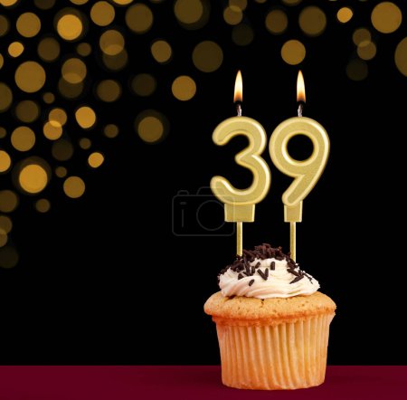 Photo for Number 39 birthday candle - Cupcake on black background with out of focus lights - Royalty Free Image