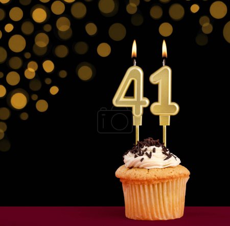 Photo for Number 41 birthday candle - Cupcake on black background with out of focus lights - Royalty Free Image