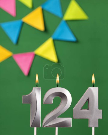 Foto de Número de vela 124 cumpleaños - Tarjeta de aniversario verde con banderines - Imagen libre de derechos