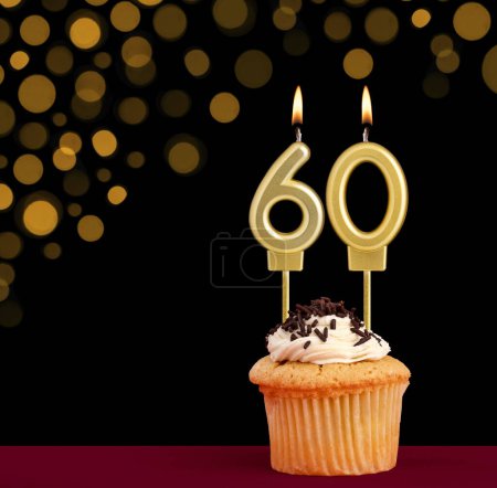Photo for Birthday candle with cupcake - Number 60 on black background with out of focus lights - Royalty Free Image