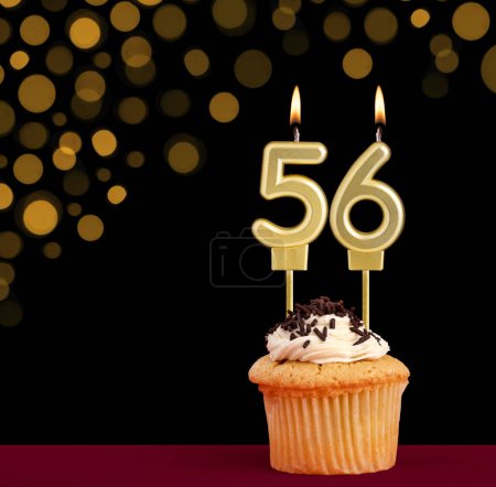 Photo for Birthday candle with cupcake - Number 56 on black background with out of focus lights - Royalty Free Image