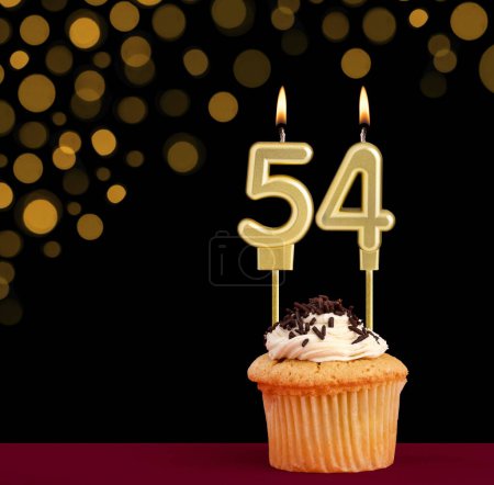 Photo for Birthday candle with cupcake - Number 54 on black background with out of focus lights - Royalty Free Image
