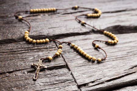 Photo for Catholic rosary holy necklace on wooden background - Royalty Free Image