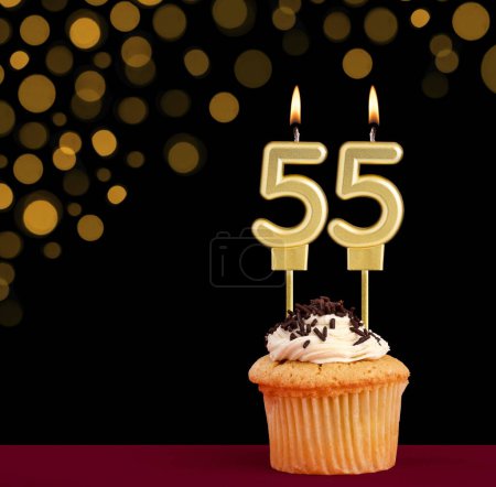Photo for Number 55 birthday candle - Cupcake on black background with out of focus lights - Royalty Free Image