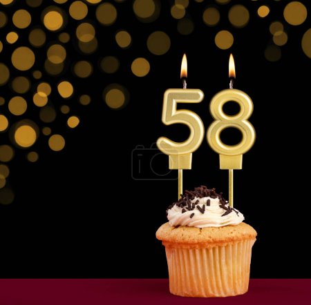 Photo for Birthday candle with cupcake - Number 58 on black background with out of focus lights - Royalty Free Image