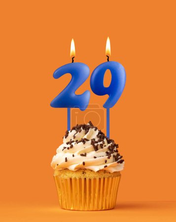 Foto de Vela azul número 29 - Cumpleaños magdalena sobre fondo naranja - Imagen libre de derechos